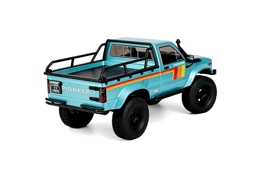Rear three-quarter studio view of the light blue RGT Pioneer V2 Pro 1/10 scale RC rock crawler truck.