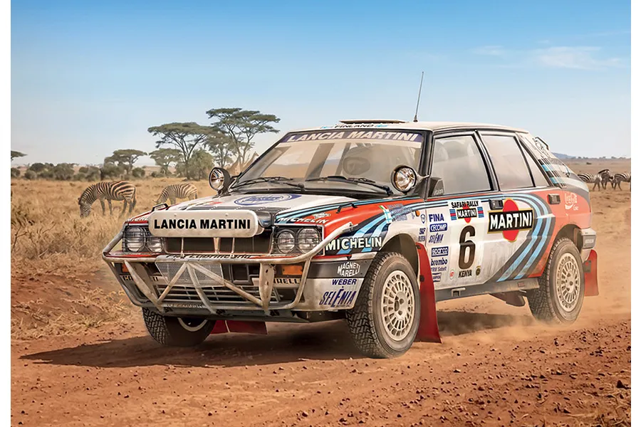A Lancia Delta Integrale rally car driving on a dusty dirt road in an African savanna with zebras in the background.