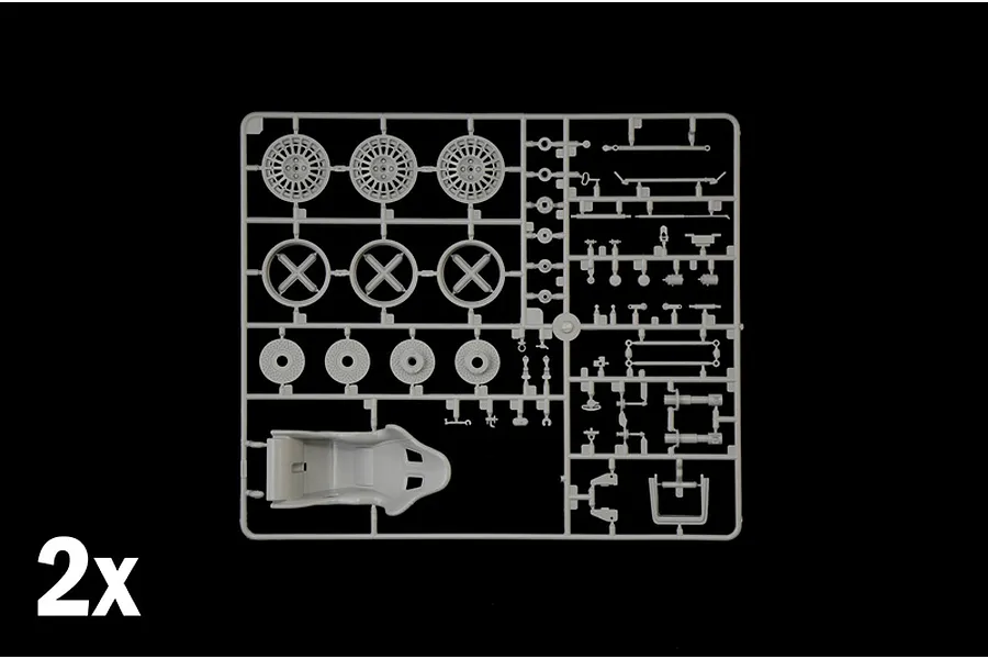 Grey plastic model kit parts sprue featuring wheels, brake discs, and a bucket seat with a 2x indicator.