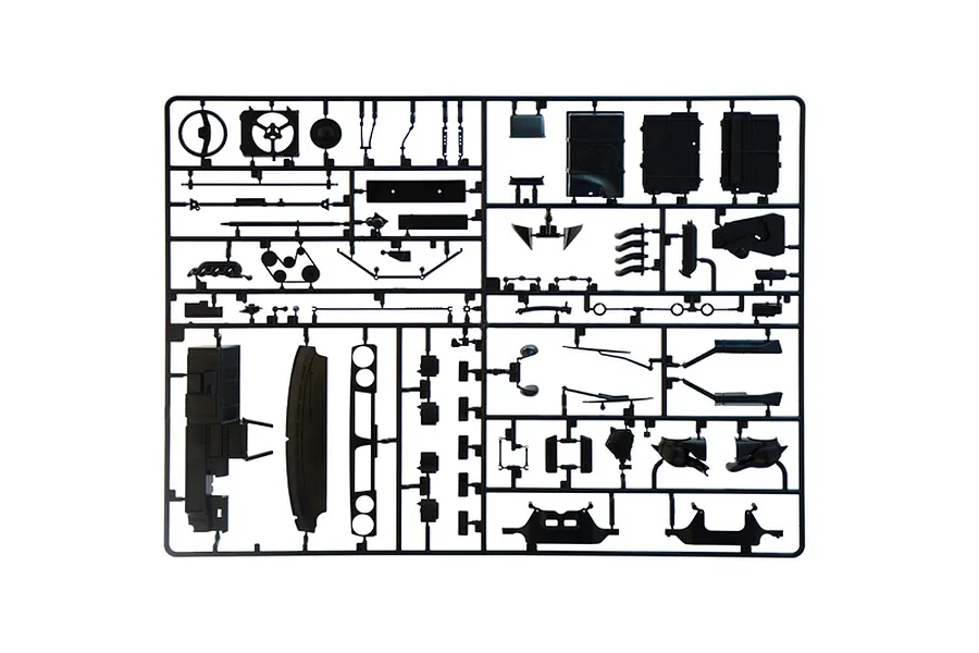 A black plastic model kit sprue containing various automotive parts against a plain white background.