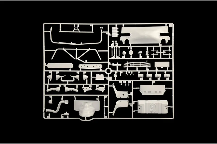 A molded white plastic model kit parts sprue featuring various car parts and accessories against a black background.