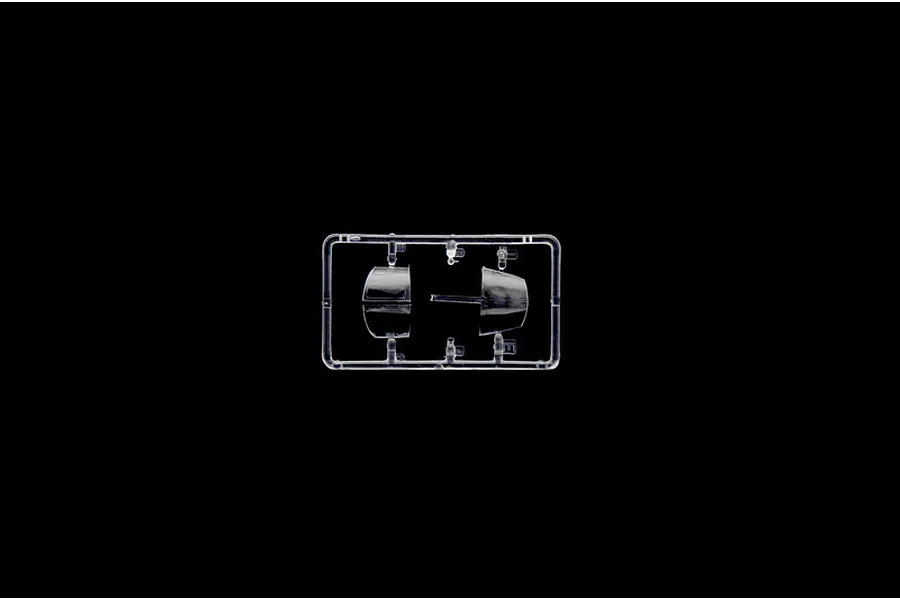 Clear plastic sprue containing transparent model aircraft canopy parts against a black background.