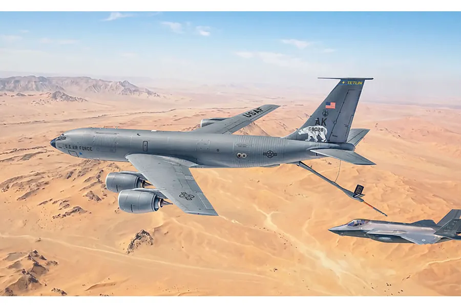 A US Air Force KC-135 Stratotanker flying over a desert landscape with another fighter aircraft nearby.