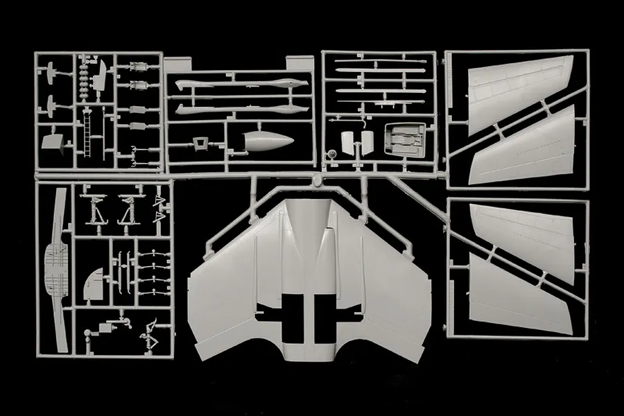 Grey plastic model kit sprue frames containing aircraft parts against a black background.