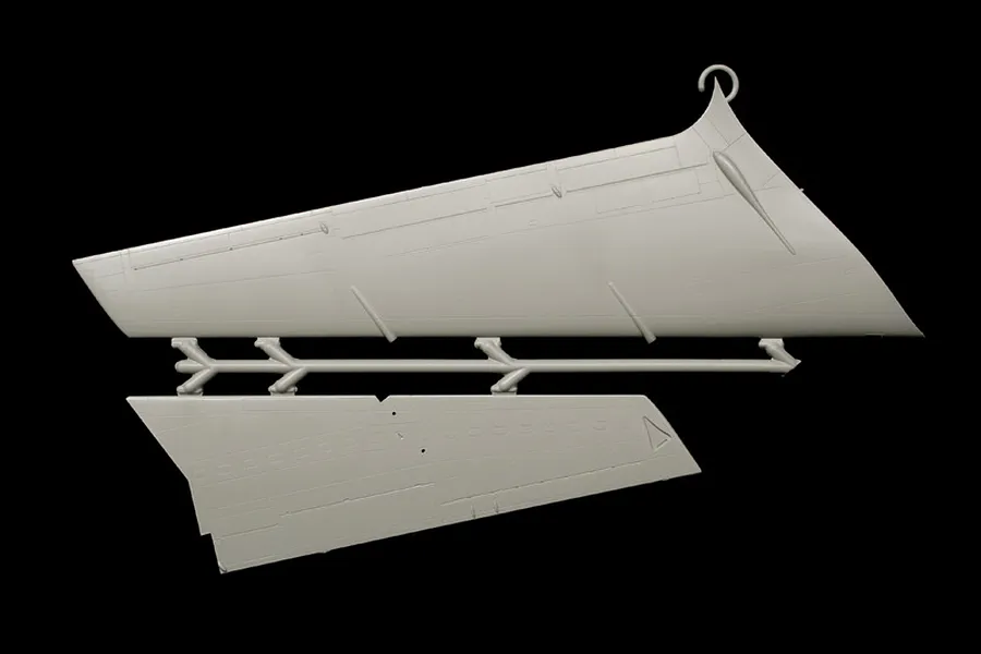 Grey plastic model kit parts sprue showing aircraft wing and tail sections on a plain black background.