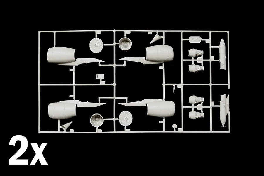 Grey plastic model sprue featuring aircraft engine parts and nacelles against a black background with a 2x indicator.
