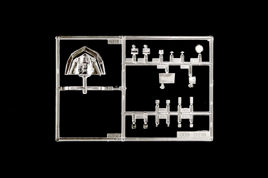 Clear plastic model parts sprue featuring cockpit canopy and small transparent pieces on a black background.