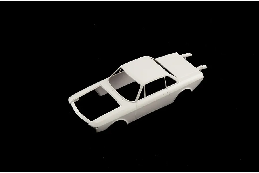 Unpainted white plastic scale model car body shell shown from a high angle view against a solid black background.