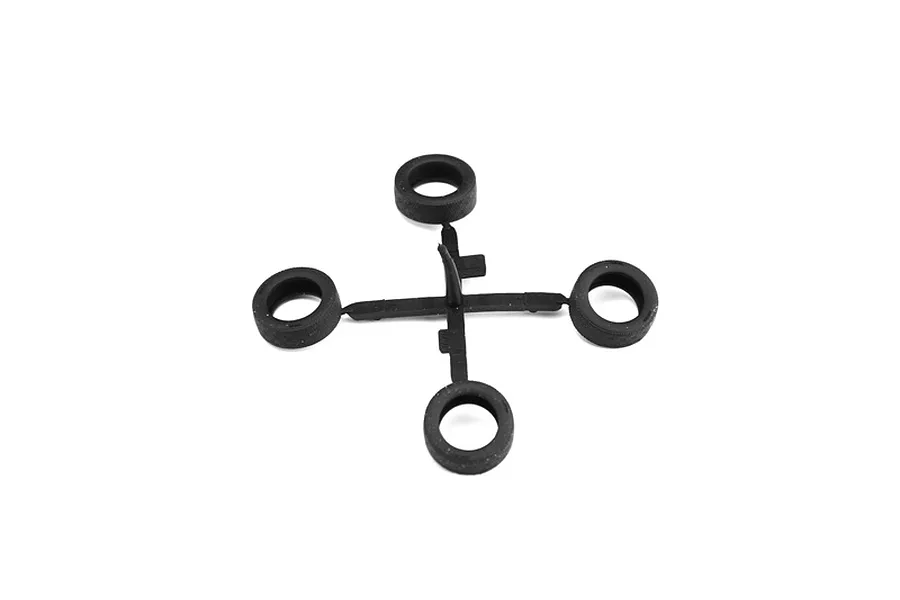 A sprue of four black rubber or plastic model car tires on a clean white background.
