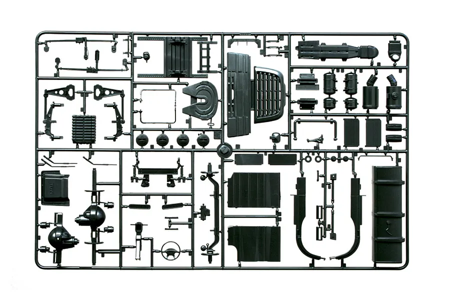 Black plastic model kit sprue containing various truck parts such as chassis components, suspension, and tanks.