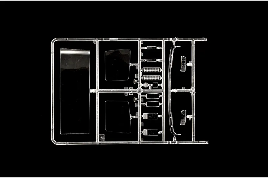 Clear plastic model sprue featuring windows and transparent parts for the Italeri 1/24 DAF XF 95 truck kit against a black background.