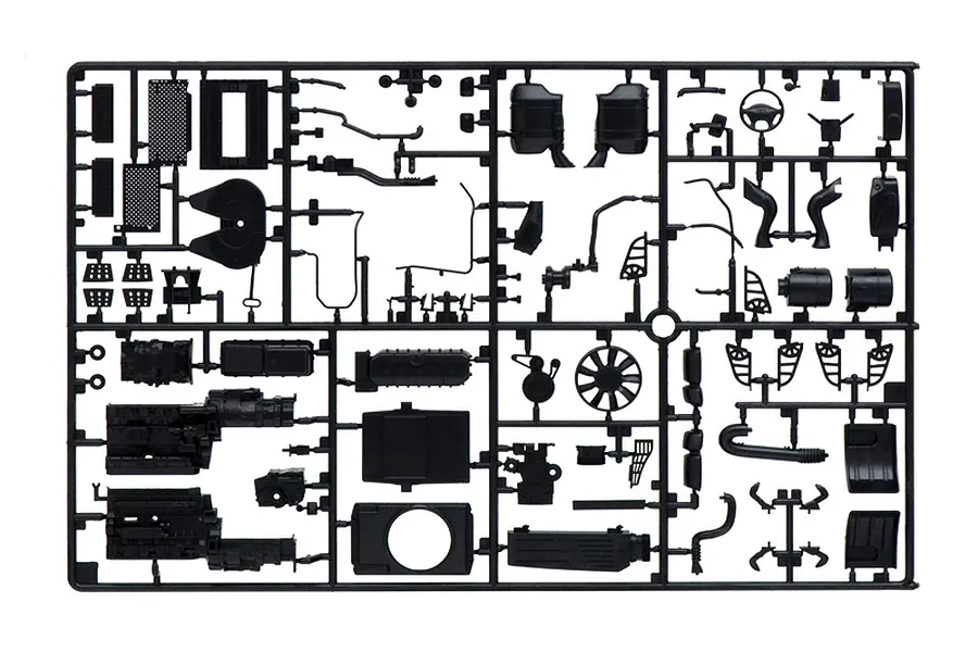 A black plastic model kit sprue containing various unattached parts for a 1/24 scale model truck.