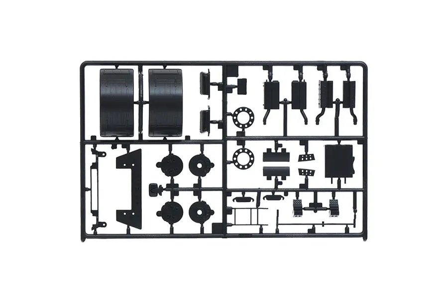 Black plastic model kit sprue containing various truck parts such as fenders, exhaust components, and brackets on a white background.