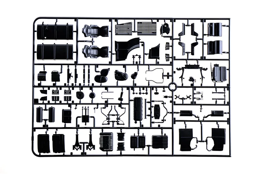 Black plastic model kit parts sprue featuring various interior and chassis components against a white background.