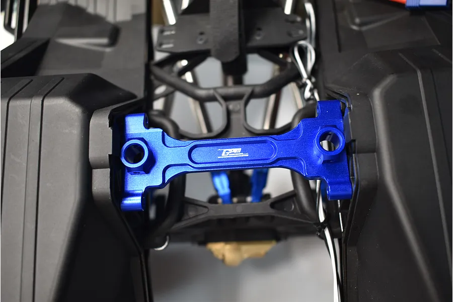 GPM blue aluminium rear chassis brace installed on an RC vehicle chassis.