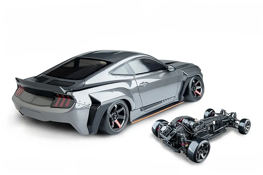 MST MTRTR 275 grey RC drift car body with widebody styling and separate chassis on a clean white background.