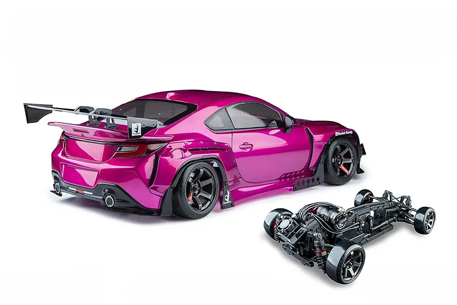 Magenta MST GR86RB RC drift car body with a large rear wing, shown alongside its black chassis against a clean white background.