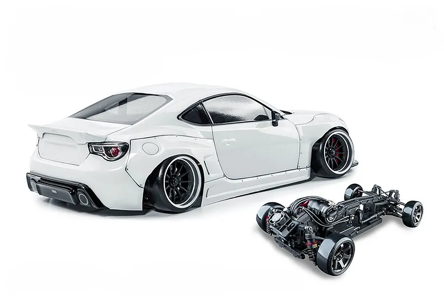 White MST 86RB RC drift car shown with a white body shell and a separate black chassis on a plain white background.