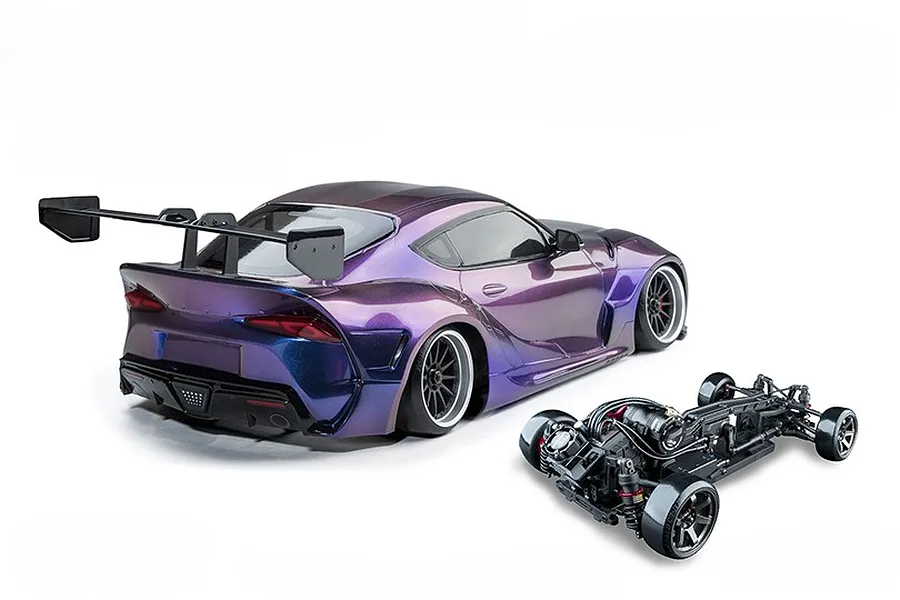 MST A90RB RC drift car body in iridescence purple with a large rear wing, shown alongside its separate black chassis on a white background.