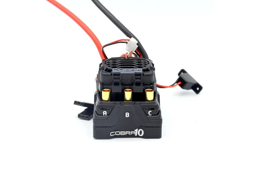 Castle Creations Cobra 10 ESC shown from the front angle with visible golden bullet connectors and wiring against a white background.