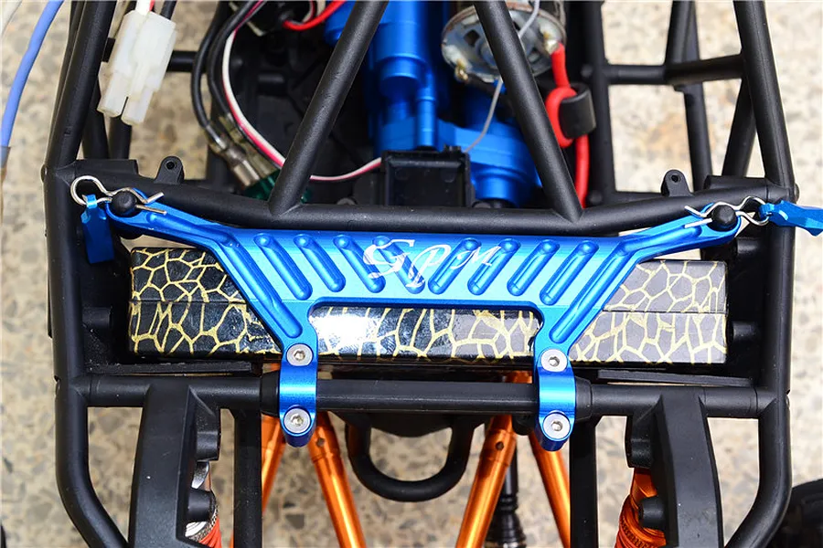 Top-down view of an RC car installed with a blue GPM aluminium upper chassis plate mounted across the frame.