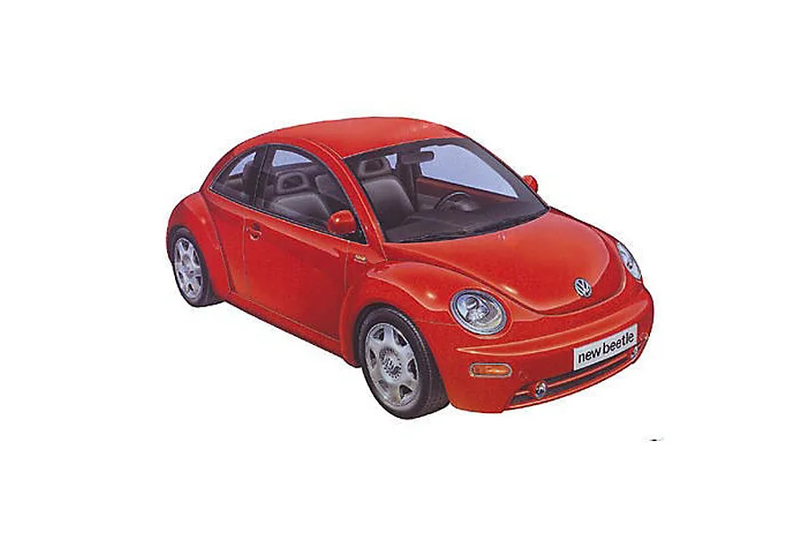 A studio shot of a red Tamiya 1/24 scale Volkswagen New Beetle plastic model car, shown from a high-angle front three-quarter view.