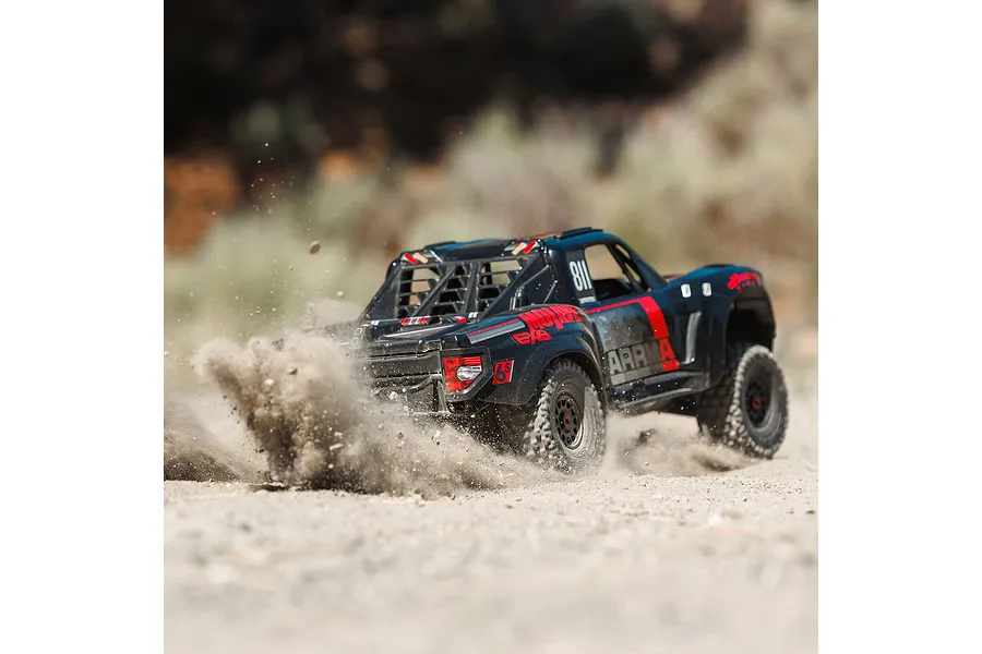 ARRMA Mojave 6S desert truck kicking up dust on a dirt track in an outdoor setting