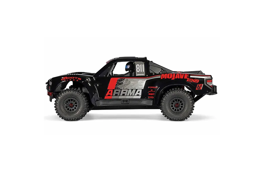 Studio side profile of the ARRMA MOJAVE 6S 1/7 EXB black desert truck featuring red and grey sponsor graphics.
