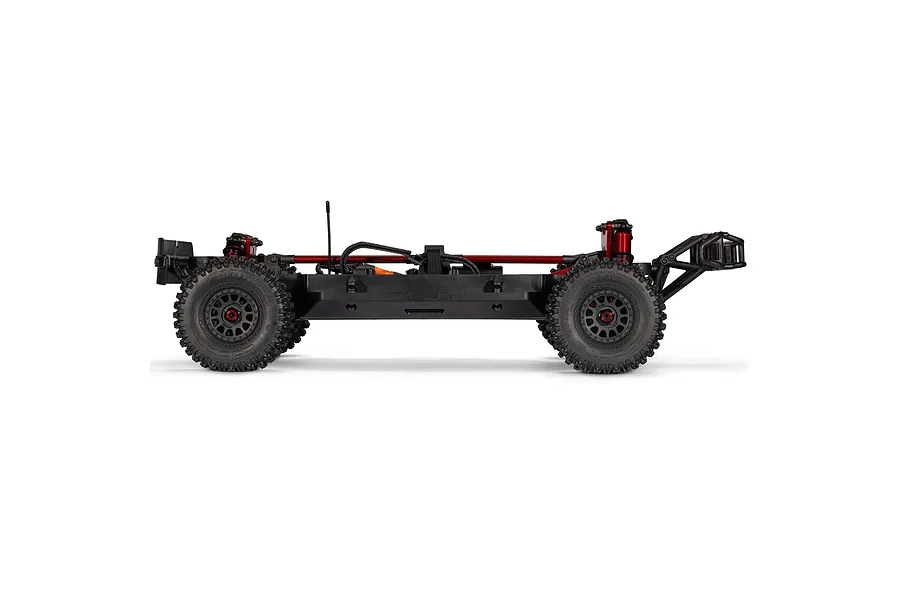 Side profile view of the ARRMA MOJAVE 6S EXB chassis on a clean white background, highlighting the black chassis, red brace, and rubber wheels.