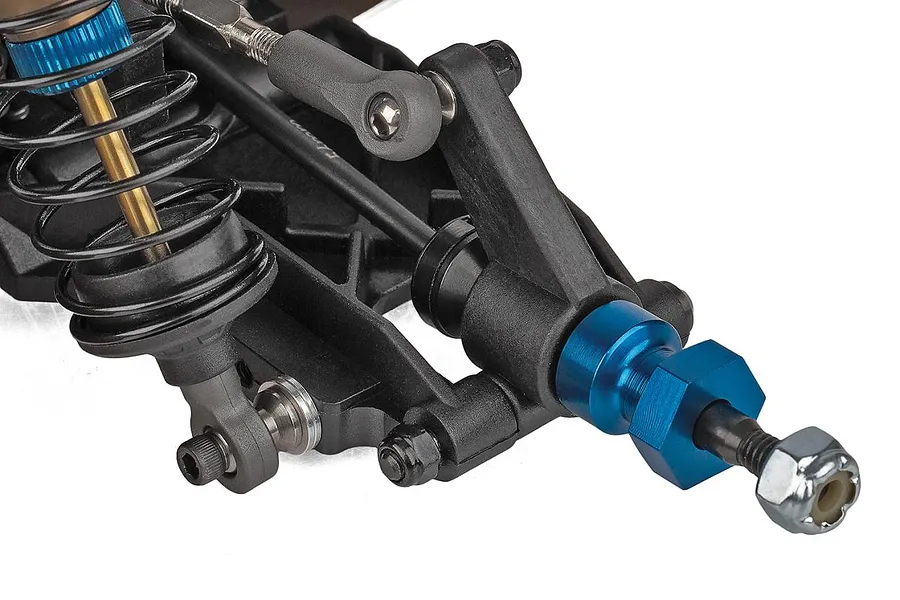 Close-up studio view of the front suspension, shock absorber, and blue anodized wheel hex on the Team Associated RC10 Factory Team Blue Edition kit.