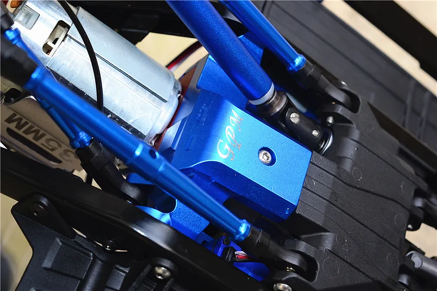 Close-up view of a blue GPM aluminium lower gear case cover installed on an RC car chassis with links and motor.