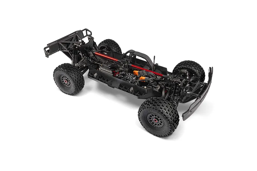 Top down angled studio view of the Arrma Mojave 6S chassis, showing electronics, chassis braces, and wheels without the body shell.