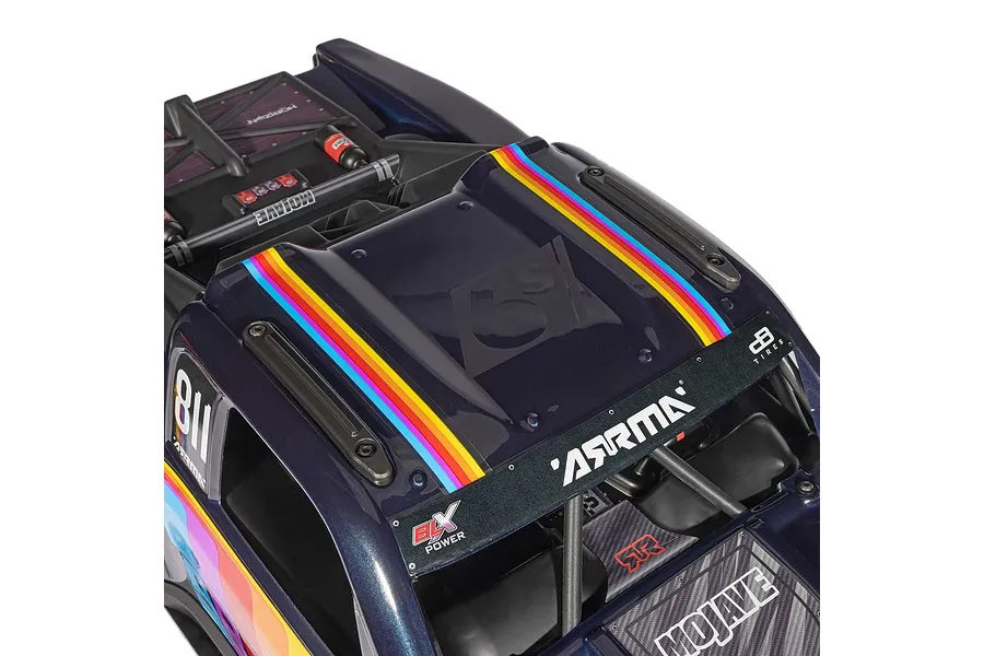 Top down close up of the blue ARRMA Mojave 6S RC short course truck body, showcasing multicolor stripes, branding, and scale interior details.