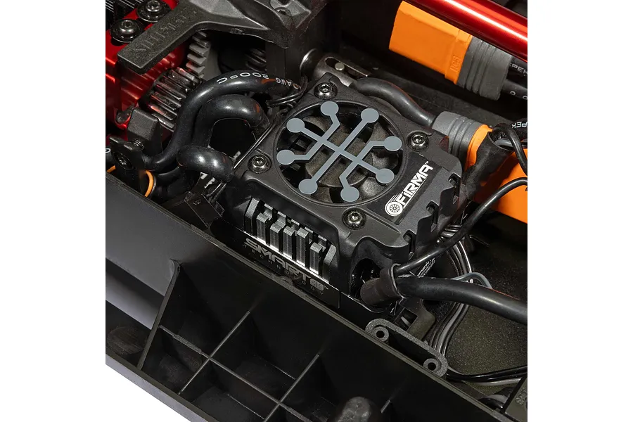 Close-up of the installed Firma electronic speed controller and wiring inside the chassis of an Arrma Mojave 6S RC truck.