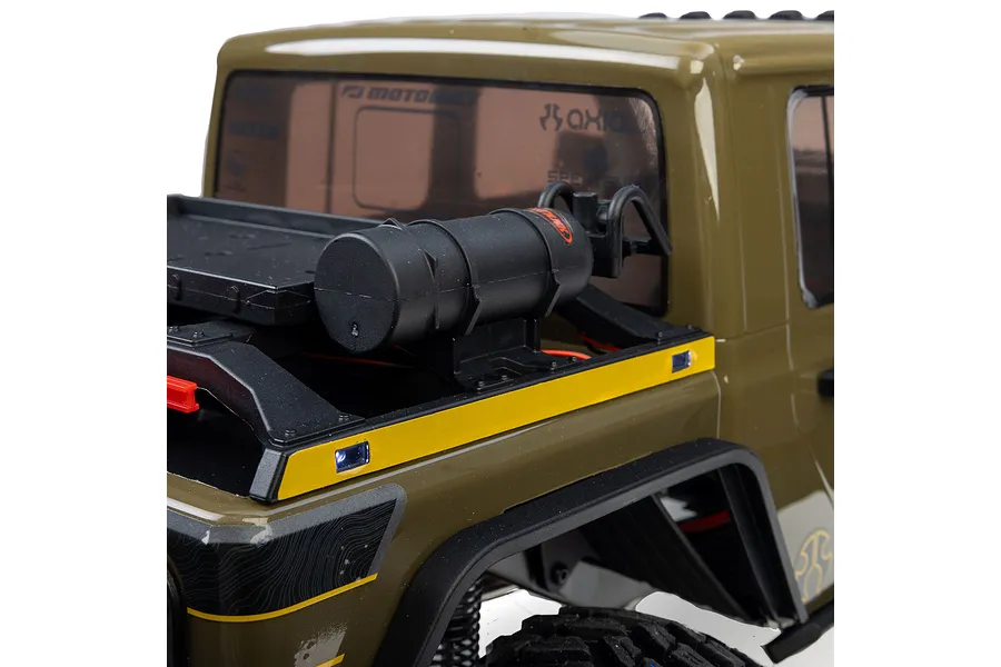 Close-up of the rear truck bed of an Axial SCX10 III Motobilt RC crawler, showing a mounted black fuel cell accessory and yellow trim.