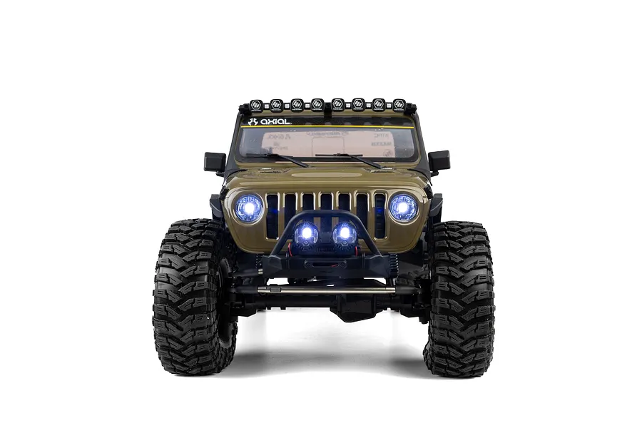 Front view of the Axial SCX10 III Motobilt Jeep JT Gladiator RC rock crawler in green, showcasing active LED headlights and light bar against a white background.