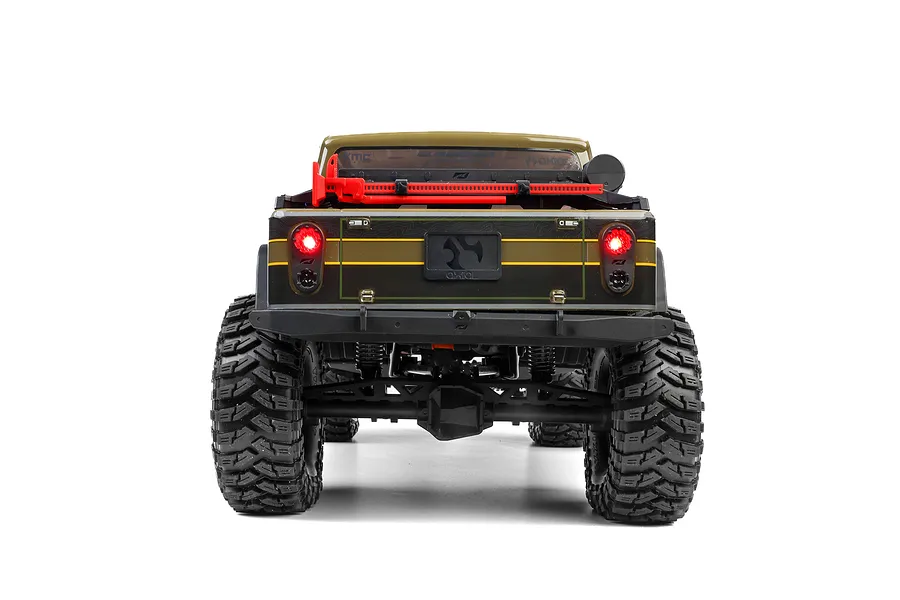 Rear view of the green Axial SCX10 III Motobilt Jeep JT Gladiator RC rock crawler showing lit tail lights and rear suspension.