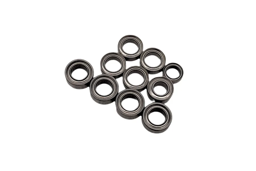 A set of various sized metal ball bearings arranged against a plain white background.