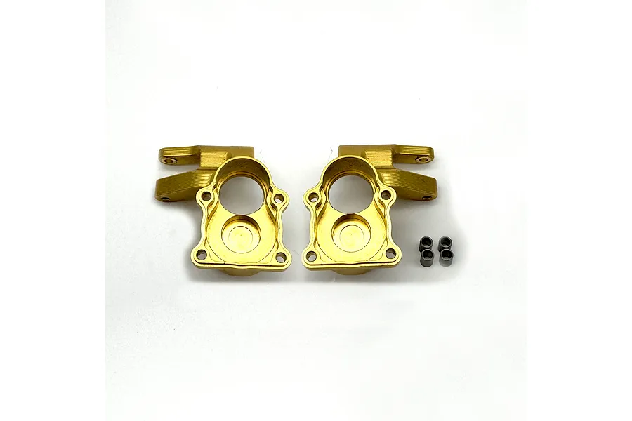 Two brass weighted steering hubs and four small metal bushings displayed on a plain white background.