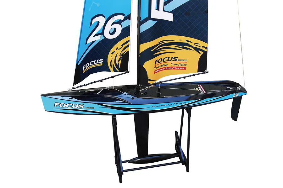 Joysway Focus V3 RC sailboat in blue and black resting on a black display stand against a white background.
