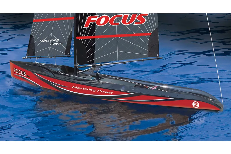 Joysway Focus V3 RC sailboat with black and red hull and sails on blue water