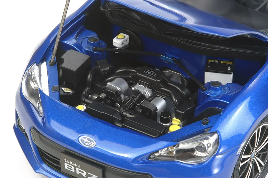 A detailed close-up of the engine bay of a blue Tamiya 1/24 scale Subaru BRZ plastic model car with the hood open.