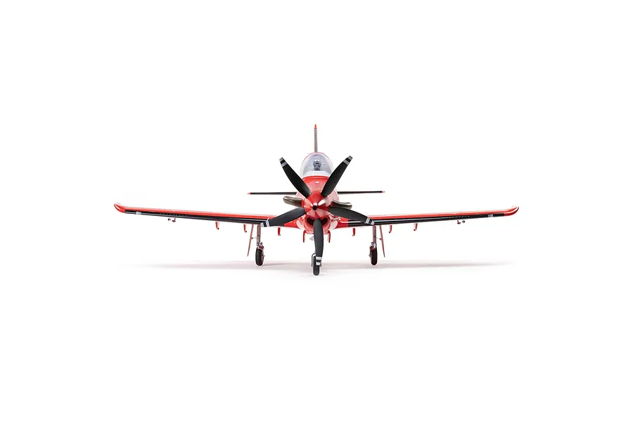 Front view of the E-Flite Pilatus PC-21 RC plane, featuring a red fuselage, black multi-blade propeller, and landing gear.
