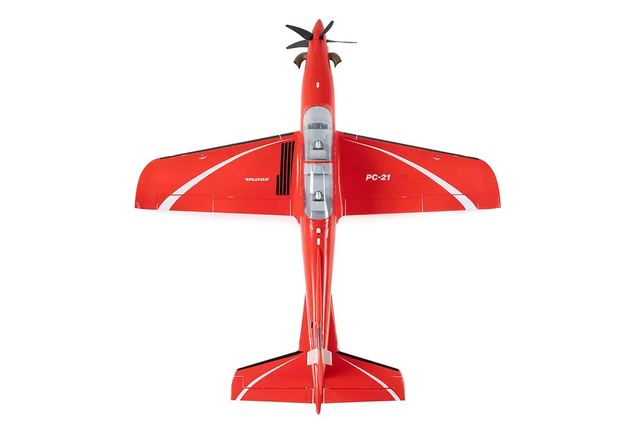 Top down studio shot of the red and white E-Flite RC Pilatus PC-21 airplane model against a plain white background.