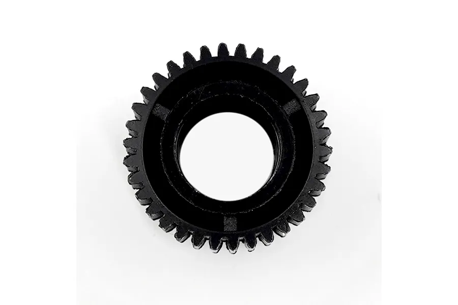 A black plastic dual transmission gear with teeth on a plain white background.