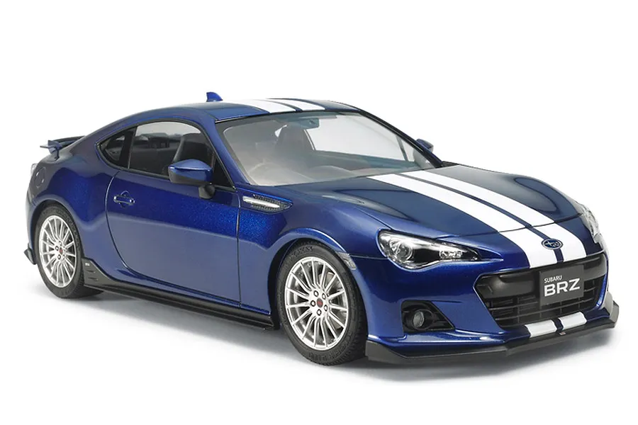 A 1/24 scale Tamiya model of a blue Subaru BRZ with white racing stripes, viewed from the front three-quarter angle on a white background.