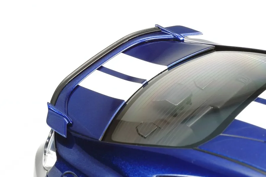 Close-up of the rear spoiler and roof section of a blue Tamiya 1/24 scale Subaru BRZ model car with white racing stripes.