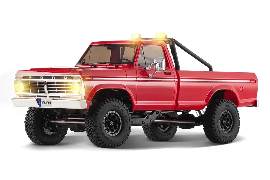 Studio product shot of the FMS FCX18 II Ford F-100 RC Rock Crawler in red with illuminated headlights and roof lights.