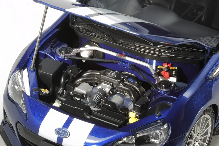 Close-up of the detailed engine bay of a 1/24 scale Tamiya Subaru BRZ model car with the hood open, showing the boxer engine and strut tower brace.