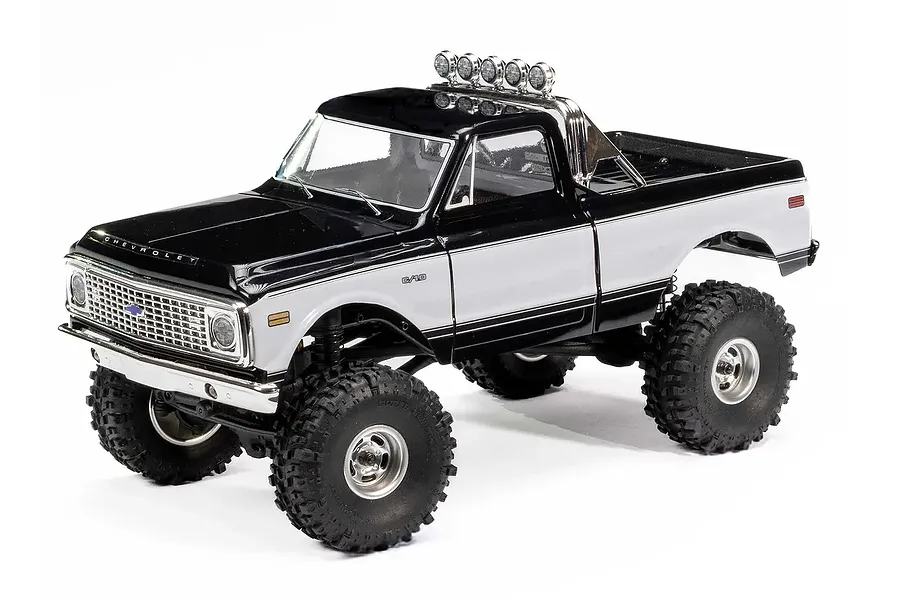 Axial SCX24 1967/72 Chevrolet C10 RC Rock Crawler in black and white finish, studio shot against a white background.